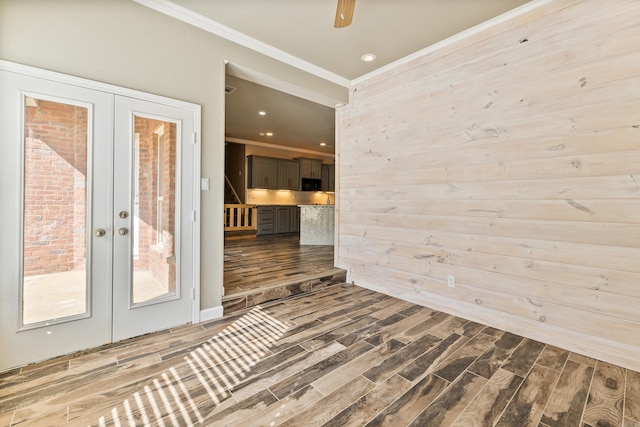 empty room with french doors, hardwood / wood-style flooring, ornamental molding, and ceiling fan