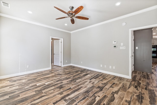 empty room featuring crown molding, ceiling fan, and dark wood-type flooring