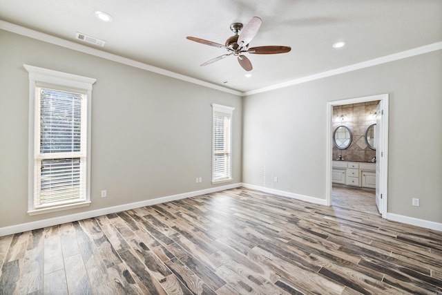 empty room featuring ceiling fan, ornamental molding, and hardwood / wood-style floors