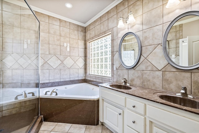 bathroom with tile patterned flooring, crown molding, vanity, and tile walls