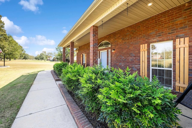 entrance to property with a lawn