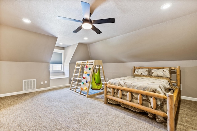 bedroom with a textured ceiling, ceiling fan, vaulted ceiling, and carpet flooring