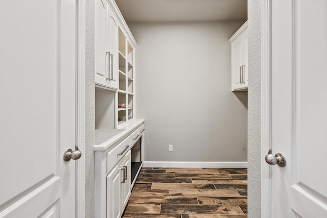 walk in closet with dark wood-type flooring