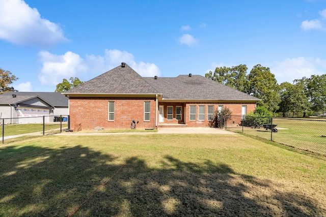 back of house featuring a lawn and a patio area