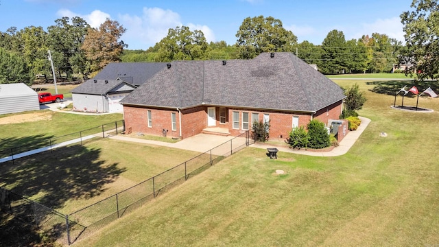 back of property featuring a lawn and a patio area