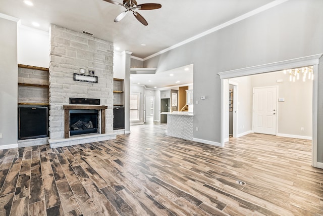 unfurnished living room with a fireplace, ornamental molding, light hardwood / wood-style flooring, and ceiling fan