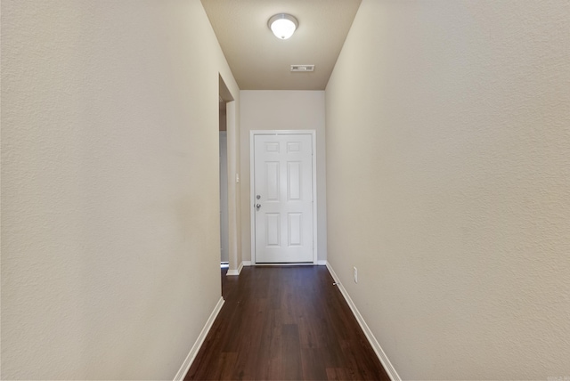 corridor with dark hardwood / wood-style floors