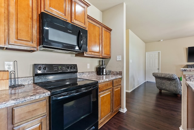 kitchen featuring light stone countertops, black appliances, and dark hardwood / wood-style flooring