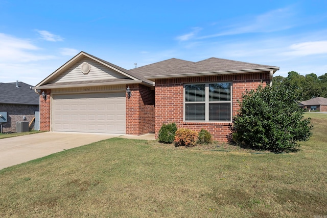 view of front of home featuring central air condition unit, a garage, and a front lawn