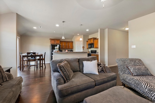 living room with ceiling fan and dark wood-type flooring