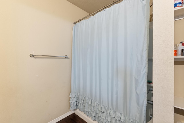 bathroom featuring a shower with curtain and hardwood / wood-style flooring