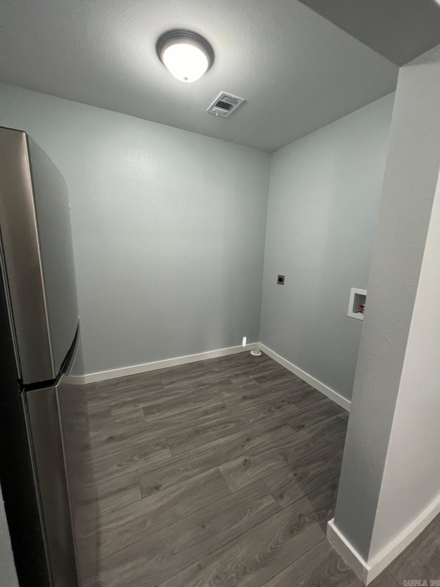 laundry room featuring dark wood-style floors, washer hookup, laundry area, electric dryer hookup, and visible vents