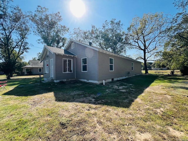 view of home's exterior with a yard