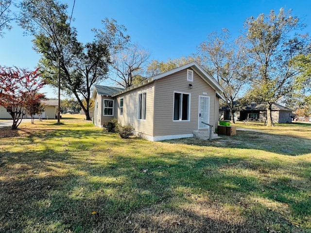 view of side of property with a lawn