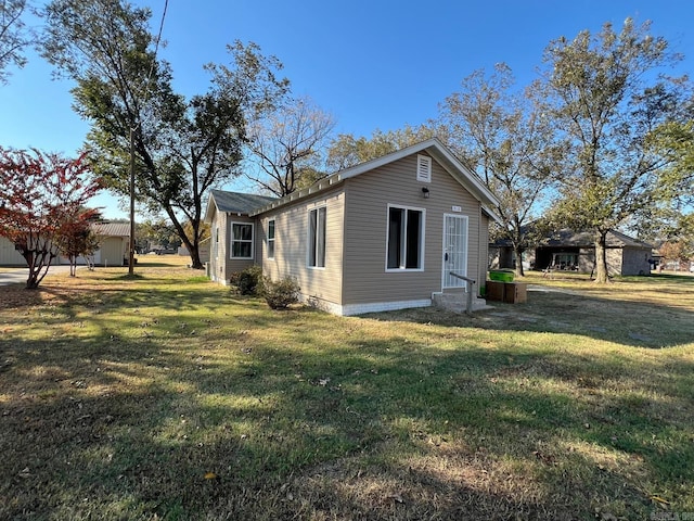 view of property exterior with a yard