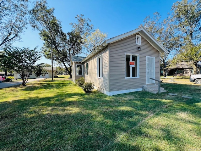 view of side of home featuring a lawn