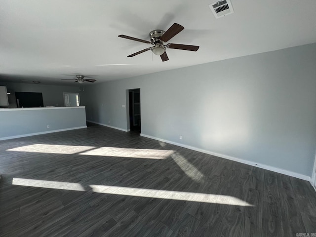 unfurnished living room with dark wood finished floors, visible vents, ceiling fan, and baseboards