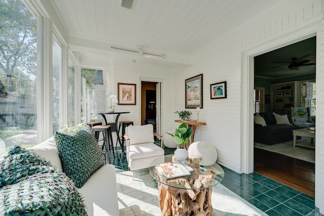 sunroom / solarium featuring ceiling fan