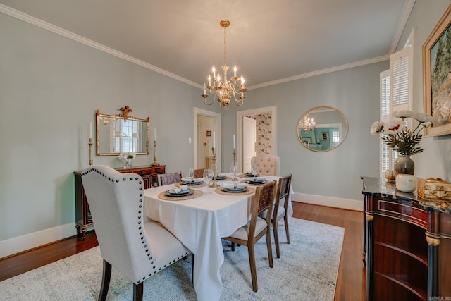 dining room featuring ornamental molding, hardwood / wood-style floors, and an inviting chandelier