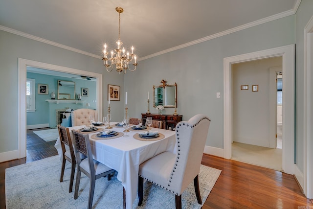 dining area featuring hardwood / wood-style flooring, crown molding, and a wealth of natural light