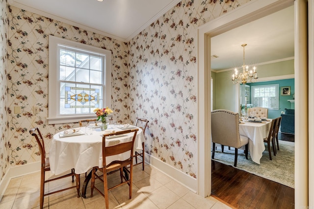 dining room featuring ornamental molding, a notable chandelier, and light wood-type flooring