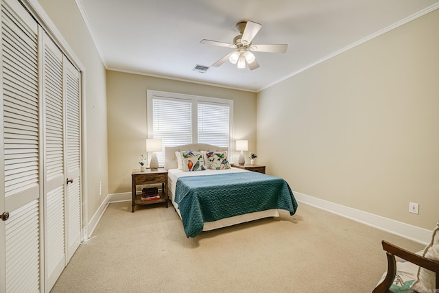 carpeted bedroom with crown molding, ceiling fan, and a closet