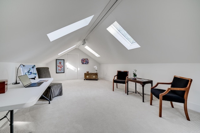 sitting room featuring track lighting, vaulted ceiling, and carpet