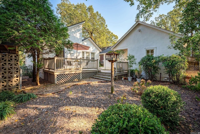 back of property with a wooden deck