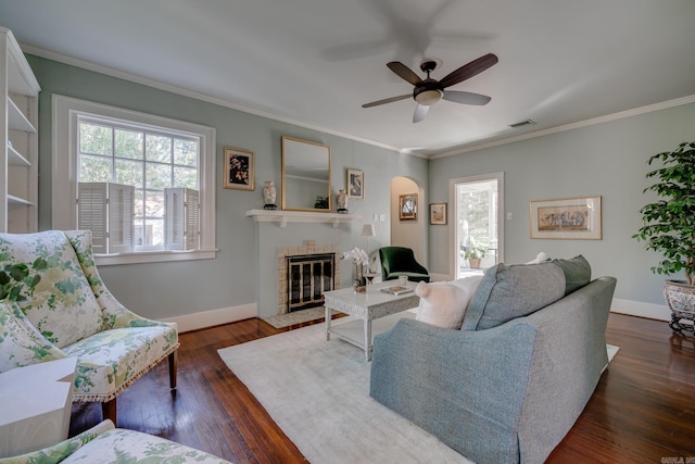 living room featuring ornamental molding, ceiling fan, and dark wood-type flooring