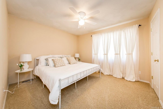 bedroom featuring ceiling fan and carpet