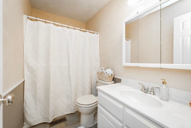 bathroom featuring tile patterned floors, vanity, and toilet