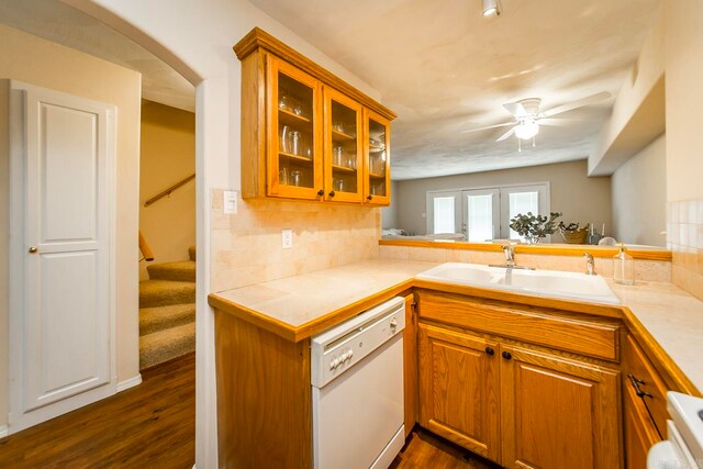 kitchen with dishwasher, kitchen peninsula, dark hardwood / wood-style flooring, and sink