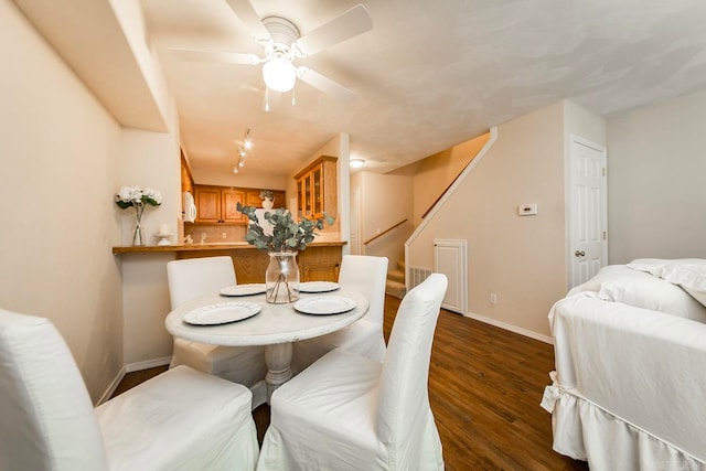 dining room featuring ceiling fan and dark hardwood / wood-style floors