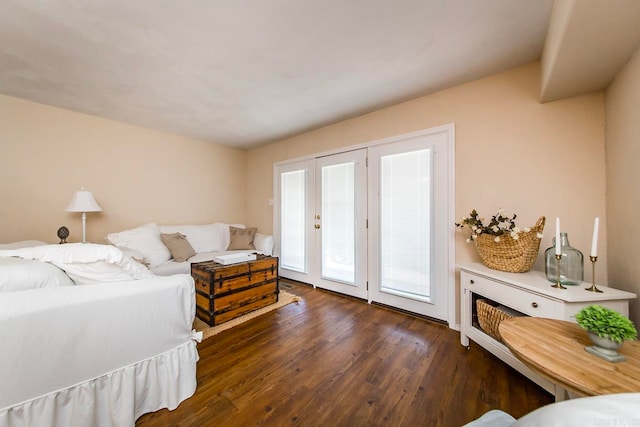 bedroom with dark wood-type flooring and access to exterior