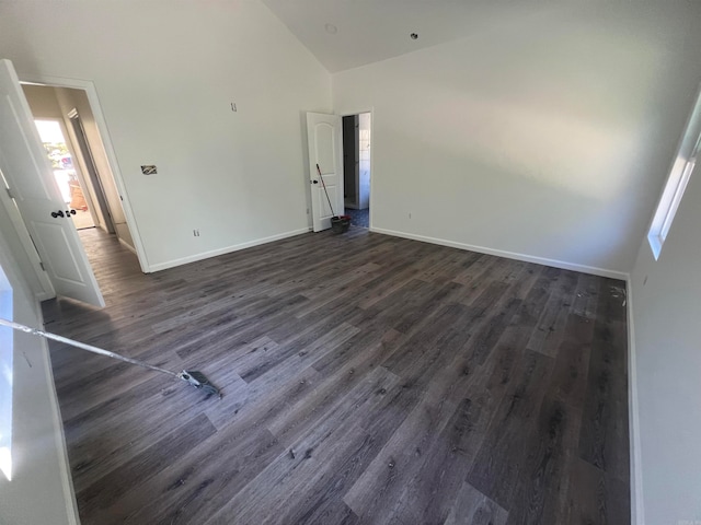 unfurnished room with dark hardwood / wood-style flooring and high vaulted ceiling