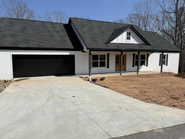 view of front of property with a garage and covered porch