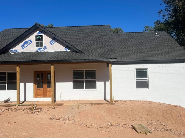 rear view of property featuring french doors