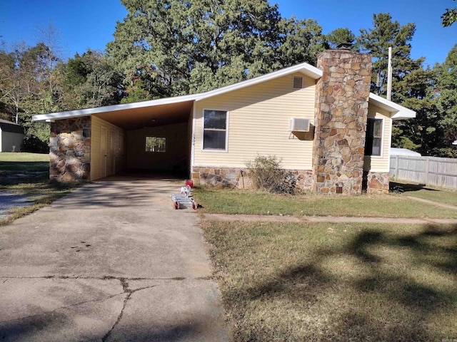 view of front facade with a front lawn and a carport