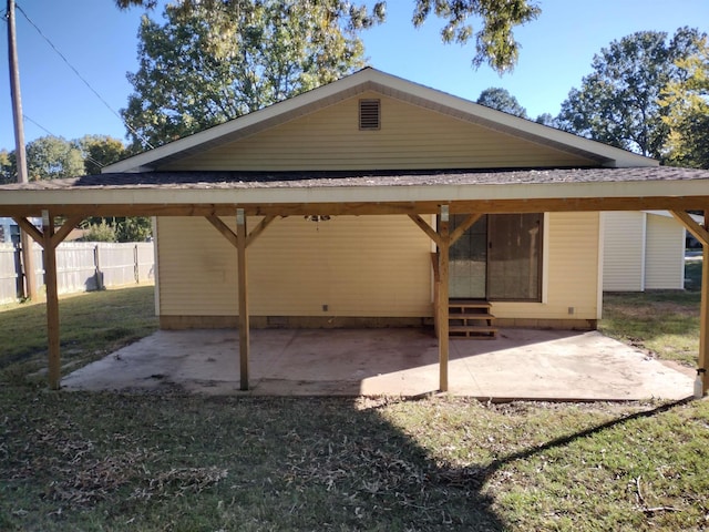 back of property featuring a yard and a patio area