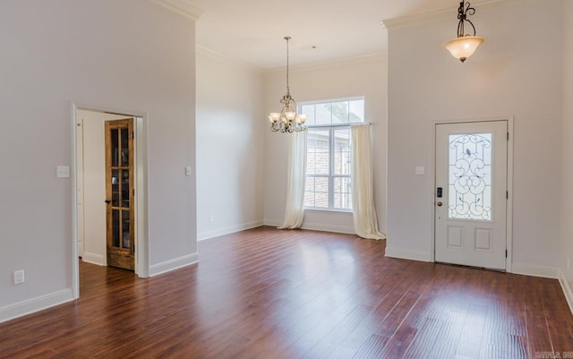 entrance foyer with crown molding, a notable chandelier, and dark hardwood / wood-style flooring