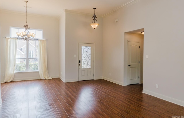 foyer featuring ornamental molding, a notable chandelier, and dark hardwood / wood-style floors