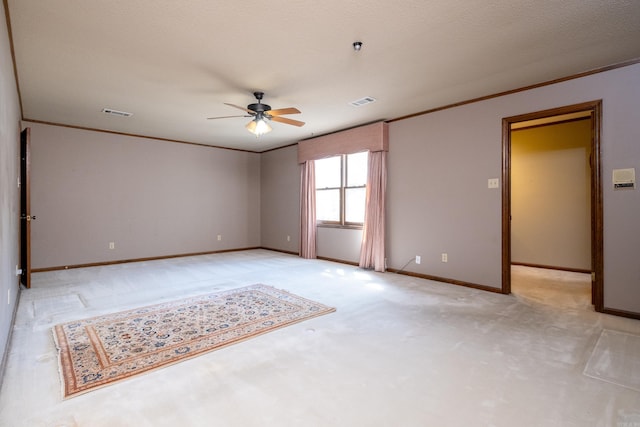 carpeted spare room with a textured ceiling and ceiling fan