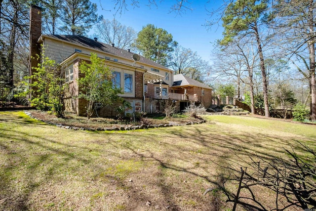 exterior space featuring a yard and a wooden deck