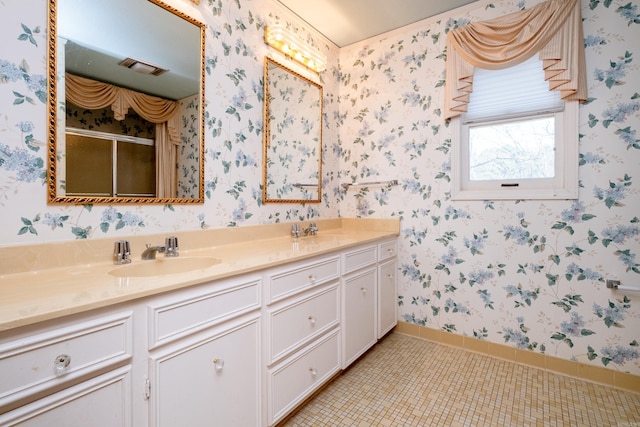 bathroom featuring vanity, tile patterned flooring, and a shower with door