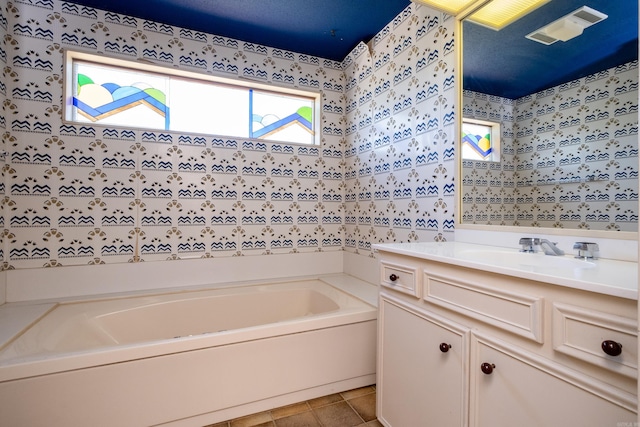 bathroom featuring a bathtub, tile patterned flooring, and vanity