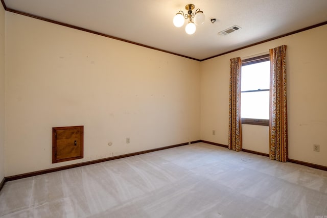 carpeted empty room featuring ornamental molding and a textured ceiling