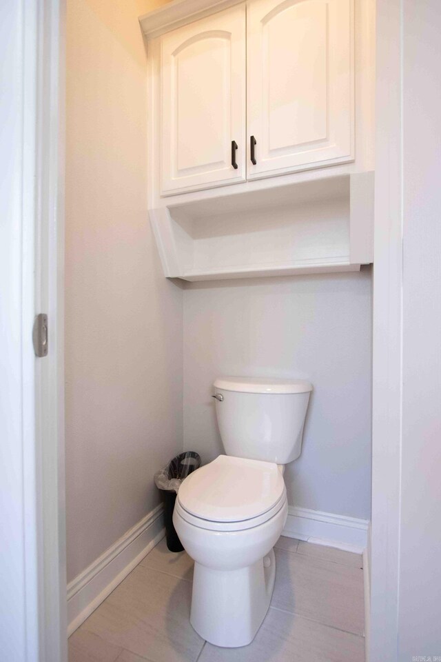 bathroom featuring toilet and wood-type flooring