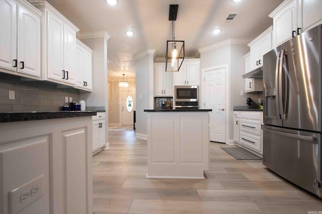 kitchen featuring decorative backsplash, decorative light fixtures, light wood-type flooring, white cabinetry, and appliances with stainless steel finishes