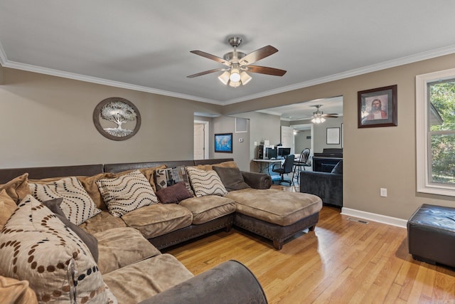 living room with light wood-type flooring, ornamental molding, a ceiling fan, and visible vents