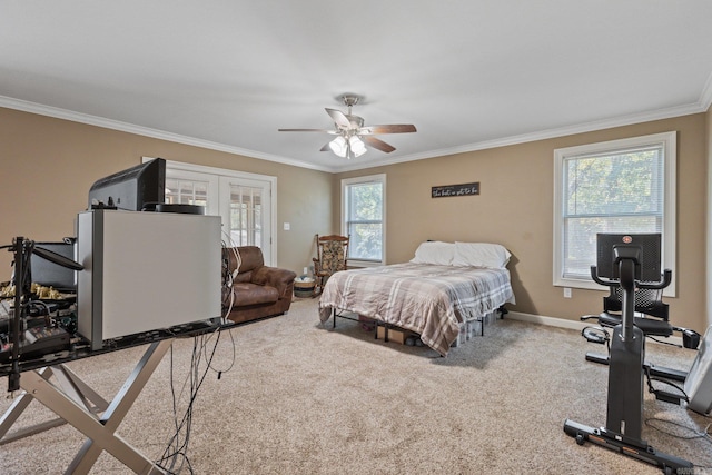 carpeted bedroom with french doors, baseboards, ornamental molding, and ceiling fan